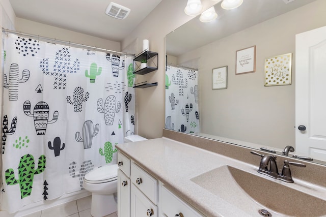 bathroom featuring tile patterned flooring, vanity, and toilet