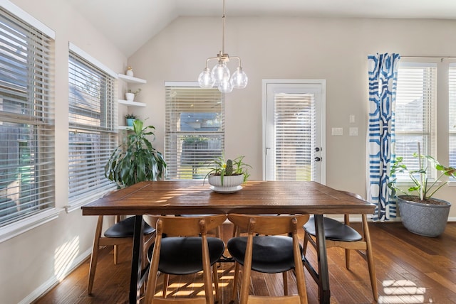 dining area featuring lofted ceiling, an inviting chandelier, and dark wood-type flooring