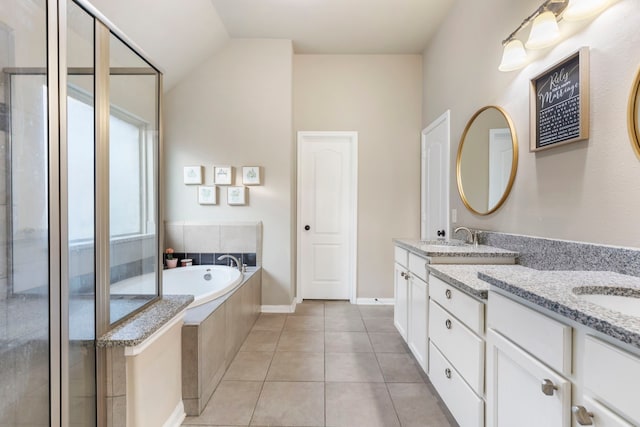 bathroom featuring lofted ceiling, separate shower and tub, tile patterned floors, and vanity