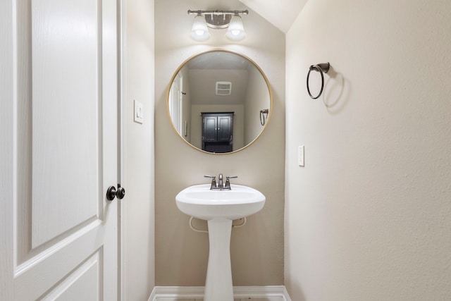 bathroom featuring vaulted ceiling