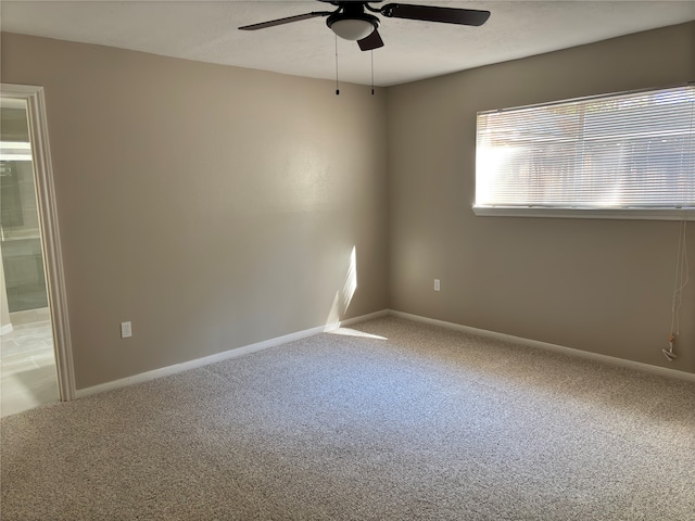 carpeted spare room with ceiling fan