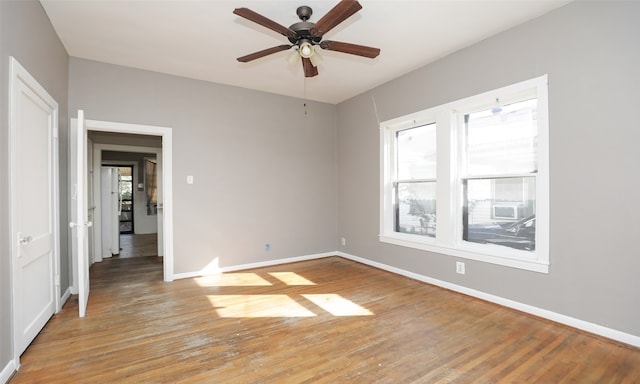 empty room featuring light wood-type flooring and ceiling fan