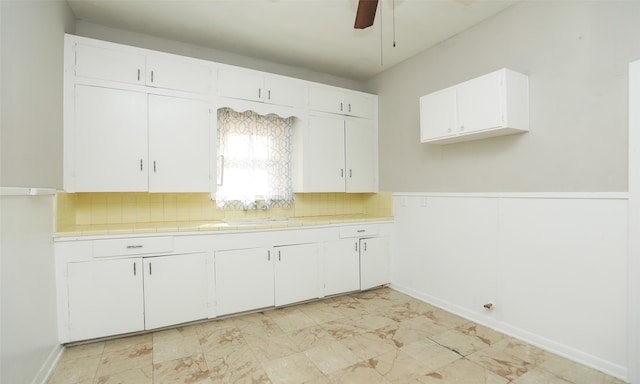 kitchen with white cabinets, backsplash, sink, and tile countertops