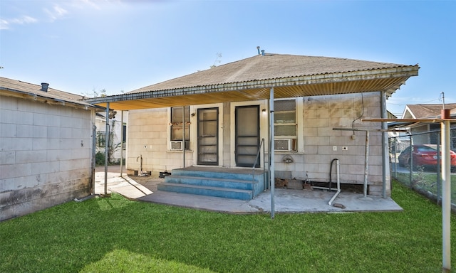 rear view of house featuring a lawn