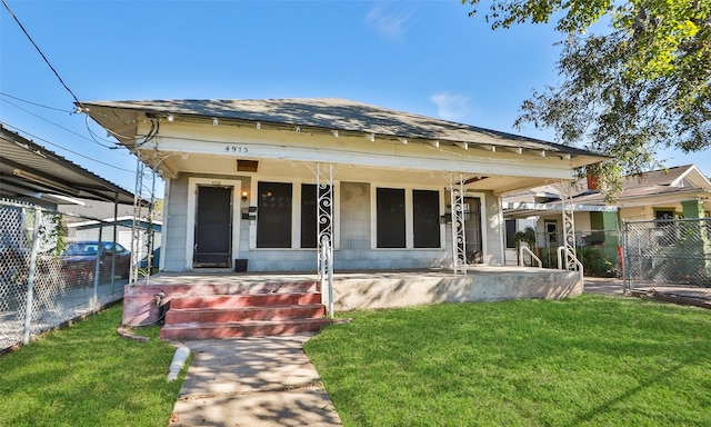 bungalow-style home with covered porch and a front lawn