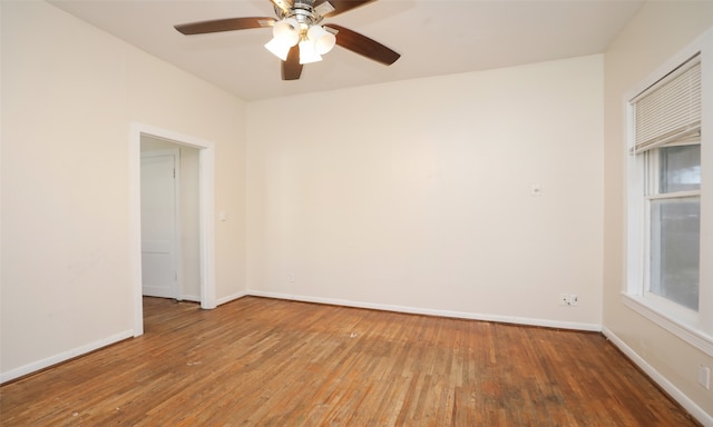 empty room with ceiling fan and wood-type flooring