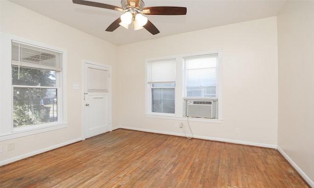 unfurnished room featuring light wood-type flooring, plenty of natural light, cooling unit, and ceiling fan