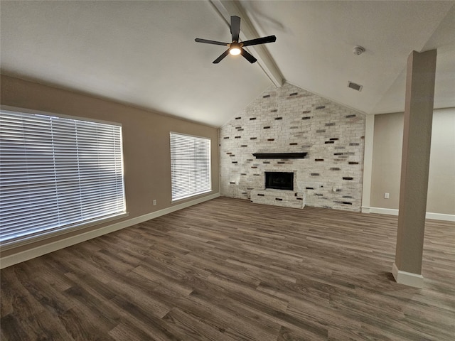 unfurnished living room featuring a fireplace, ceiling fan, dark hardwood / wood-style flooring, and lofted ceiling with beams