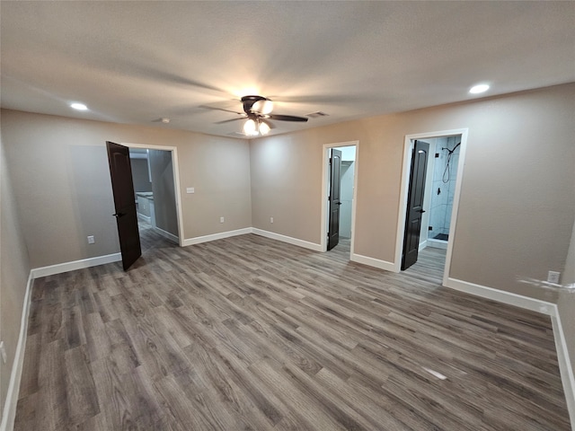 empty room with ceiling fan and hardwood / wood-style flooring