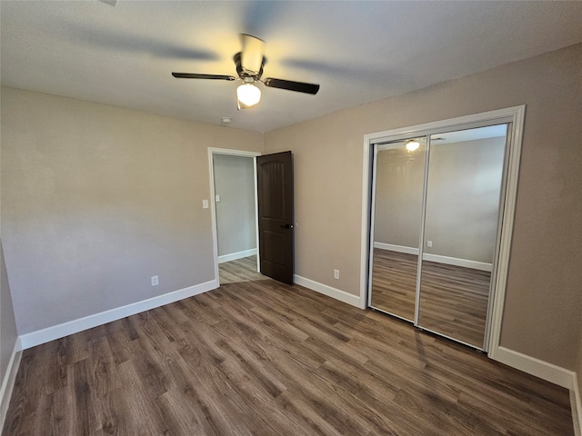 unfurnished bedroom featuring hardwood / wood-style floors, ceiling fan, and a closet