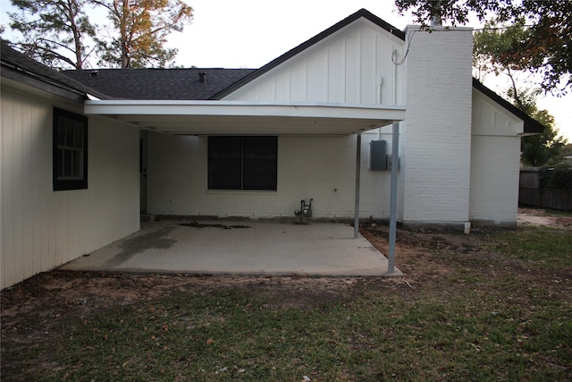 rear view of property with a lawn