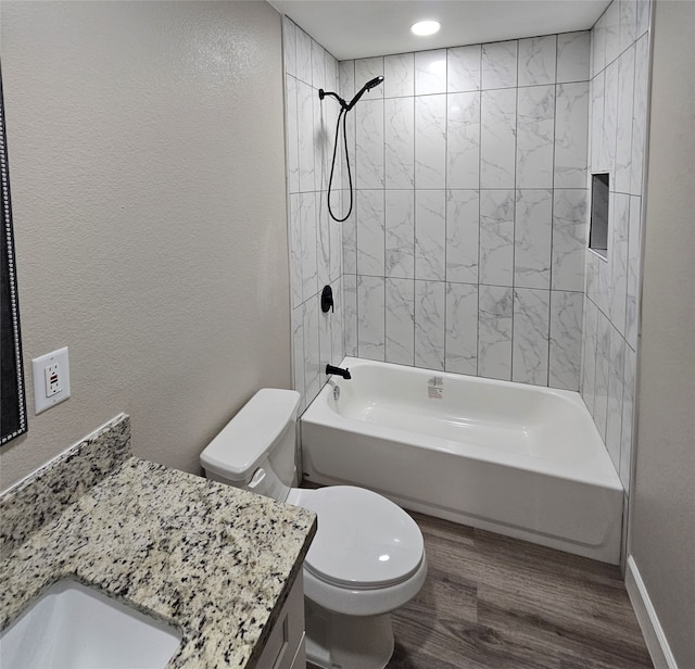 full bathroom with hardwood / wood-style floors, vanity, toilet, and tiled shower / bath