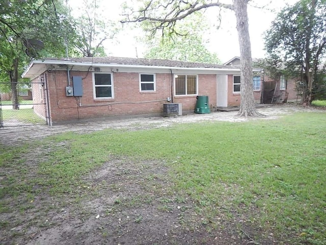 back of property featuring a yard and cooling unit