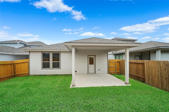 rear view of house with a yard and a patio