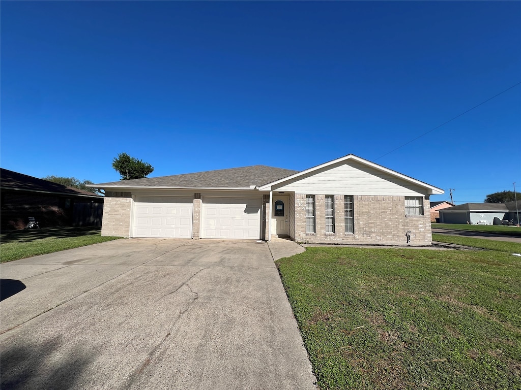 ranch-style home with a garage and a front yard