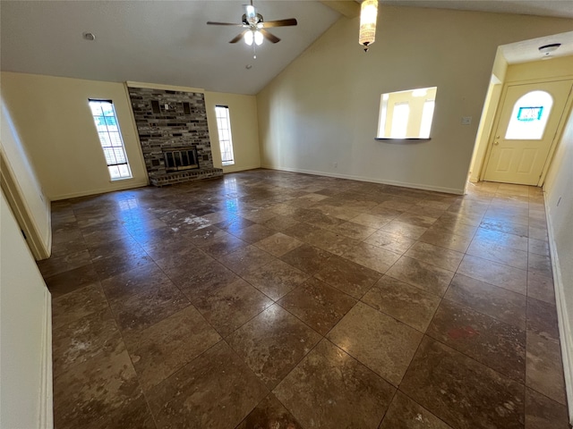 unfurnished living room with ceiling fan, a fireplace, and high vaulted ceiling