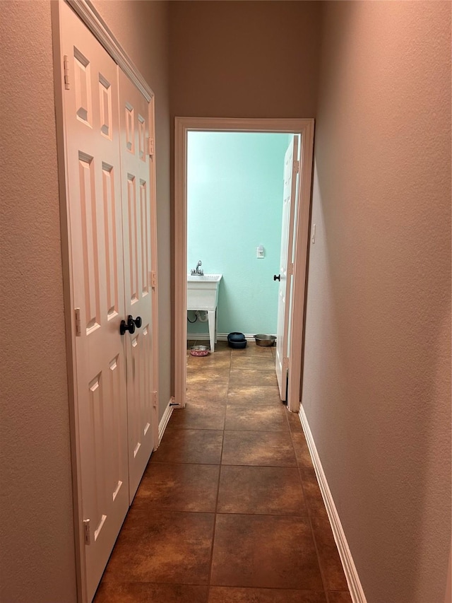 corridor featuring dark tile patterned flooring