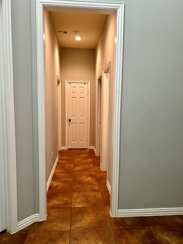 corridor with dark tile patterned floors