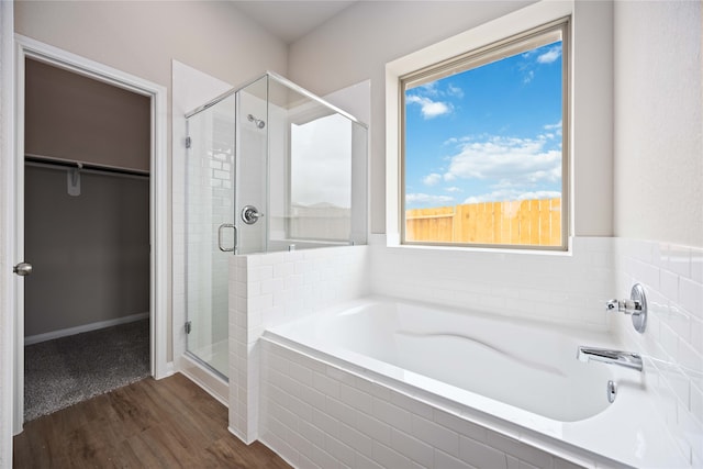 bathroom featuring hardwood / wood-style floors and shower with separate bathtub