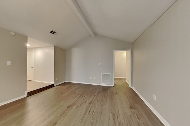 unfurnished living room with vaulted ceiling with beams and light hardwood / wood-style flooring