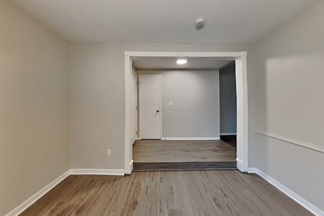 spare room with wood-type flooring and a textured ceiling