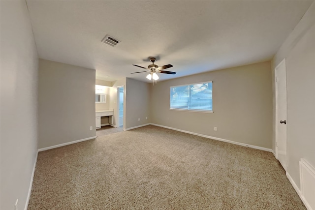 spare room featuring carpet flooring and ceiling fan