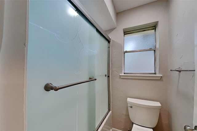 bathroom with an enclosed shower and toilet