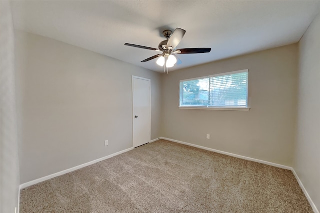 empty room featuring carpet flooring and ceiling fan