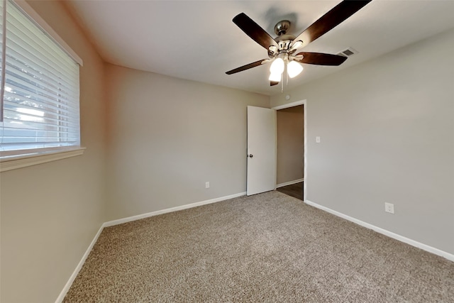 unfurnished room with carpet and ceiling fan