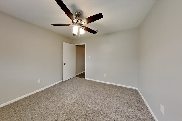 carpeted spare room featuring ceiling fan