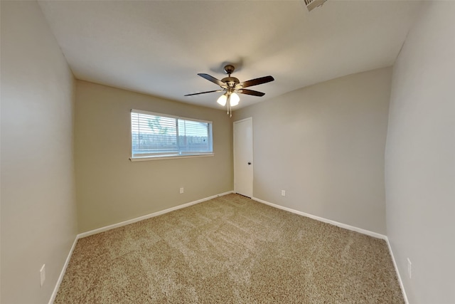 empty room with ceiling fan and carpet floors