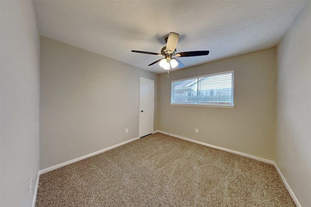 carpeted empty room featuring ceiling fan