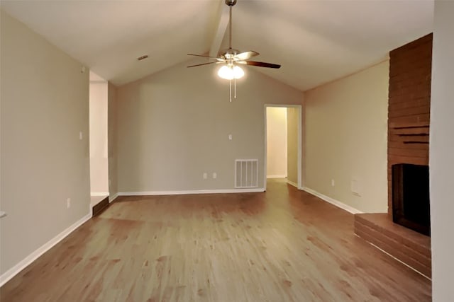 unfurnished living room with hardwood / wood-style flooring, ceiling fan, lofted ceiling, and a brick fireplace