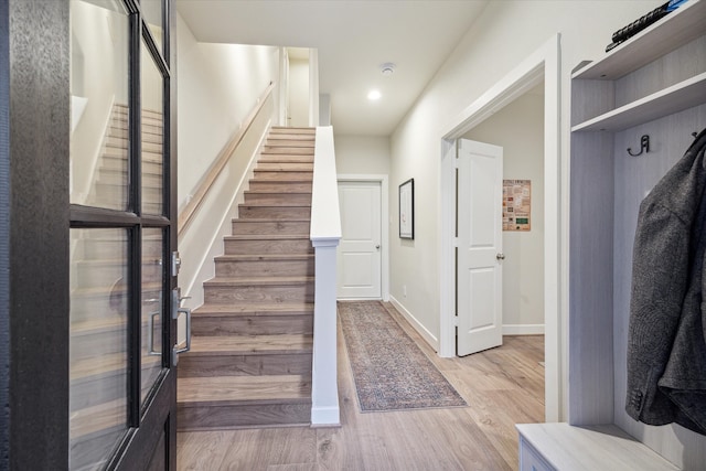 stairs featuring wood-type flooring