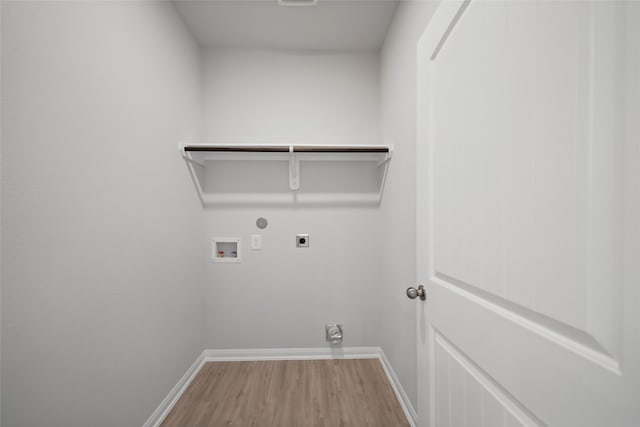 laundry area featuring hardwood / wood-style floors, electric dryer hookup, hookup for a gas dryer, and hookup for a washing machine