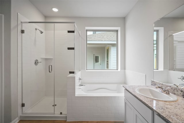 bathroom featuring separate shower and tub and vanity