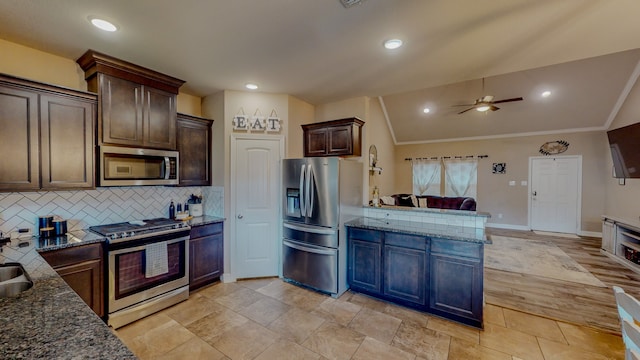 kitchen featuring lofted ceiling, ceiling fan, dark stone countertops, appliances with stainless steel finishes, and dark brown cabinetry