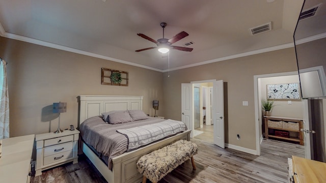 bedroom with ceiling fan, crown molding, and light hardwood / wood-style floors