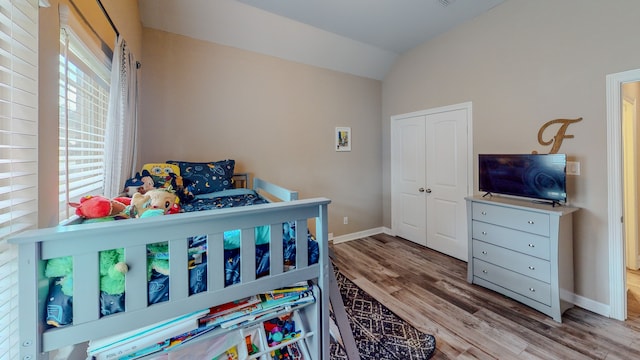 bedroom featuring hardwood / wood-style floors and lofted ceiling