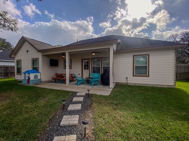 back of house with a patio, ceiling fan, and a lawn