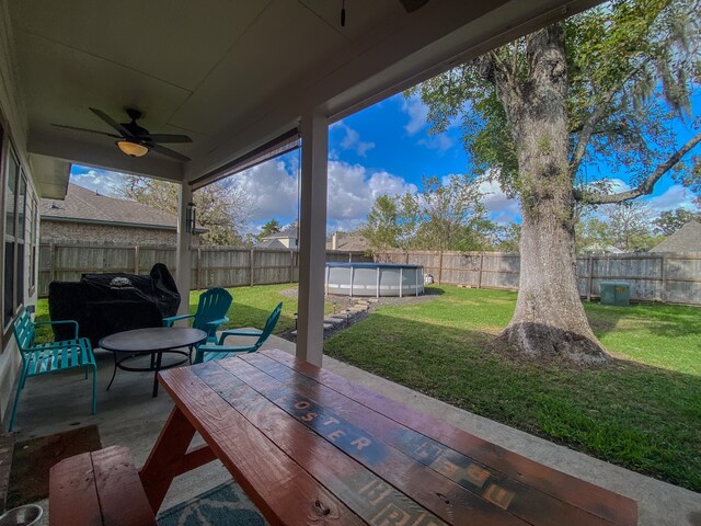 view of patio / terrace with ceiling fan and a fenced in pool