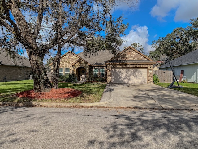 view of front of property featuring a garage and a front lawn