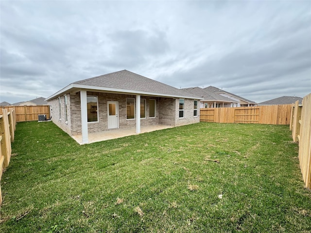 back of house with a patio and a yard