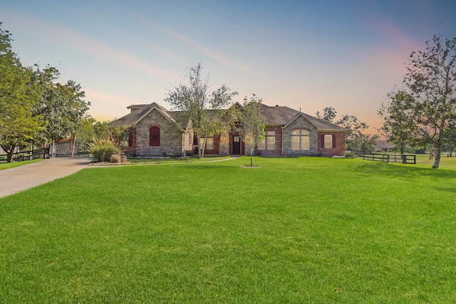 single story home featuring a yard