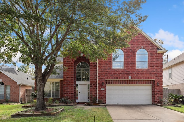 view of property with a garage and a front lawn