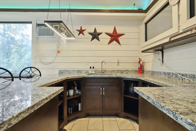 kitchen featuring light stone countertops, open shelves, a sink, and a wall mounted AC