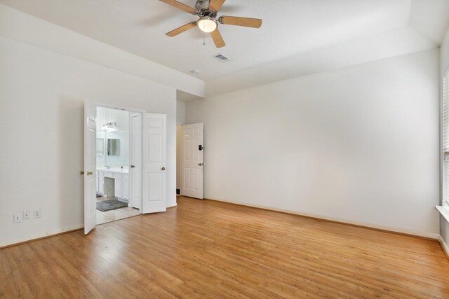 spare room with ceiling fan and light wood-type flooring