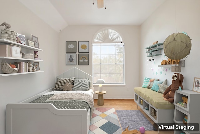 bedroom with ceiling fan, light wood-style flooring, baseboards, and vaulted ceiling