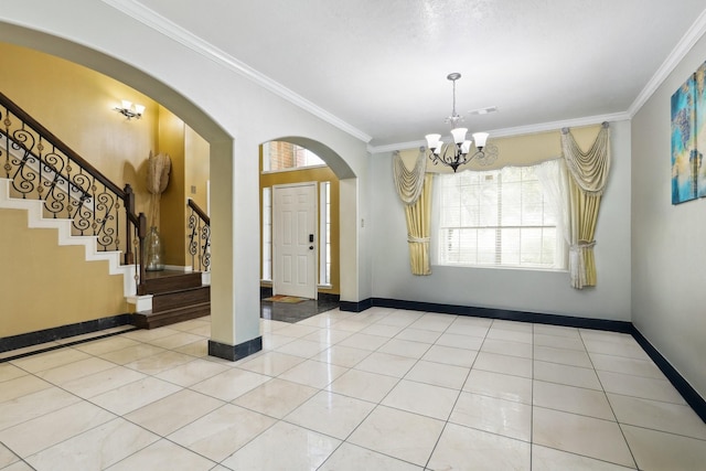 foyer with light tile patterned floors, an inviting chandelier, and ornamental molding