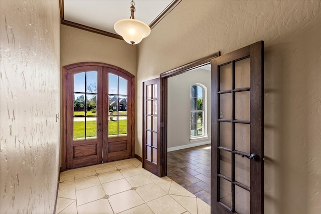 foyer entrance with french doors and ornamental molding